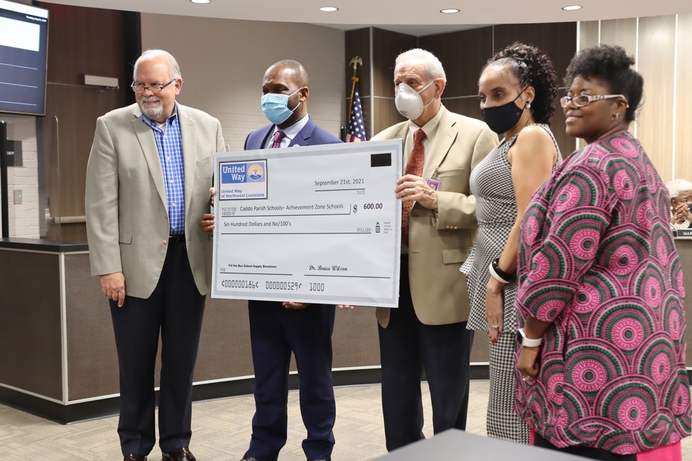 A picture of board members receiving a check from the United Way