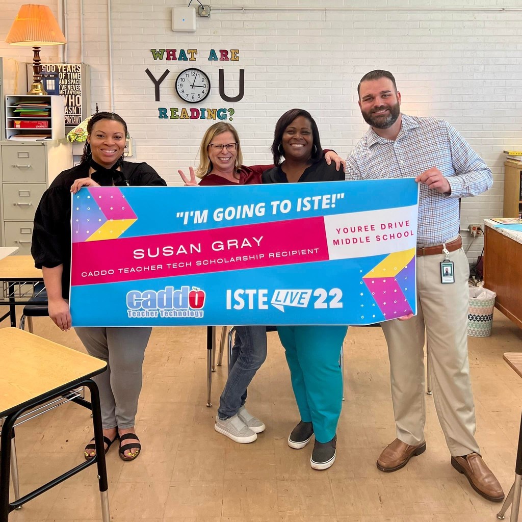 Group holds poster to celebrate going to a conference