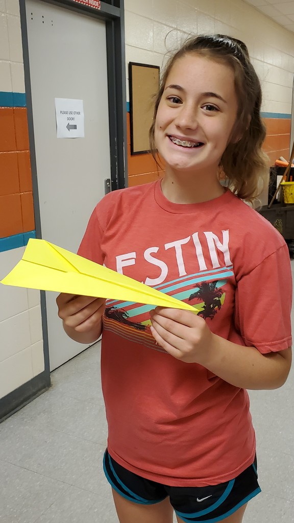 girl with yellow paper airplane